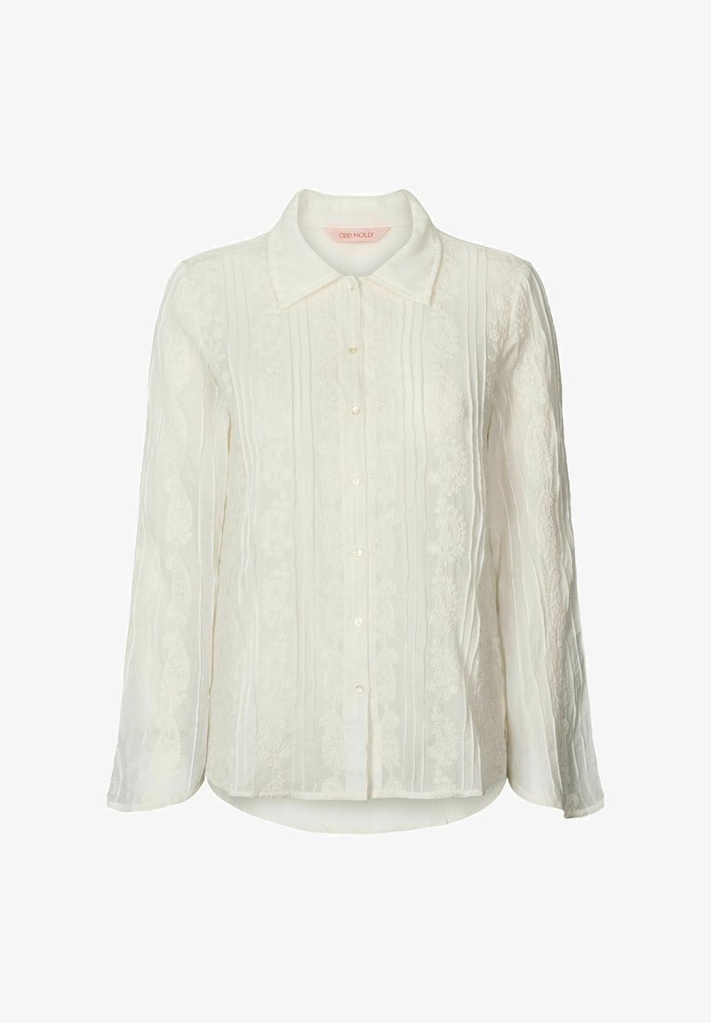 White long-sleeve blouse with button closure, textured fabric featuring vertical stripes and floral embroidery accents on the front.