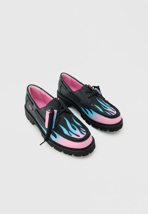 Scarpe in pelle nera con suole spesse, interni rosa e motivi di fiamme blu sulle zone rosa delle punte, con lacci neri.