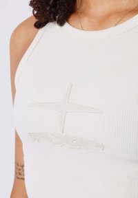 Ribbed tank top in off-white featuring tonal embroidered logo and design with a high neckline and slim fit. Soft, stretchy fabric.
