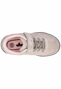 Grey suede shoe with pink accents, featuring a Velcro strap, grey laces, and a textured sole. Interior shows pink lining and logo detail.