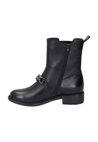 Black leather ankle boot with a low heel, side zip closure, and a decorative silver buckle accent on the front. Smooth texture and streamlined design.