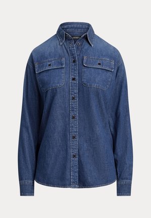 Denimskjorte, dyp blå farge, lange ermer, knappelukkedesign, to brystlommer med klaffer, synlige sømmer, avslappet passform.