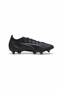 Melni futbola apavi ar teksturētu virsmu, ar elegantu dizainu, sešām uzgaļiem un baltām akcentu līnijām papildu detaļām.