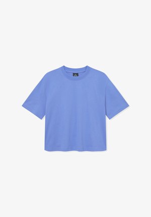 Světle modré bavlněné tričko s kulatým výstřihem, krátkými rukávy a volným střihem. Bez viditelných vzorů nebo grafik. Základní design.