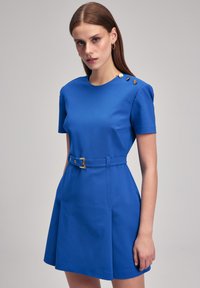 Blue short-sleeve dress with a fitted waist and belt, featuring a round neckline and decorative buttons on the shoulder. Smooth fabric texture.
