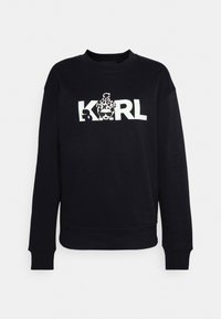 Felpa nera con colletto a girocollo, caratterizzata da un grande logo bianco "KARL" e dettagli grafici. Tessuto morbido e polsini delle maniche a costine.
