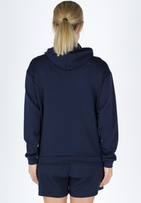 Navy blue hooded sweatshirt made of soft fabric, featuring a regular fit, long sleeves, and a kangaroo pocket at the front.