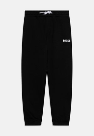 Schwarze Jogginghose mit elastischen Bündchen und Bund, weißer Kordelzug und weißes "BOSS"-Logo am linken Oberschenkel.