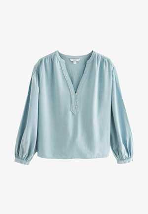 Jasnoniebieska bluzka z dekoltem w serek, zapinana na cztery guziki, z długimi, obszernymi rękawami. Wykonana z miękkiego, strukturalnego materiału.