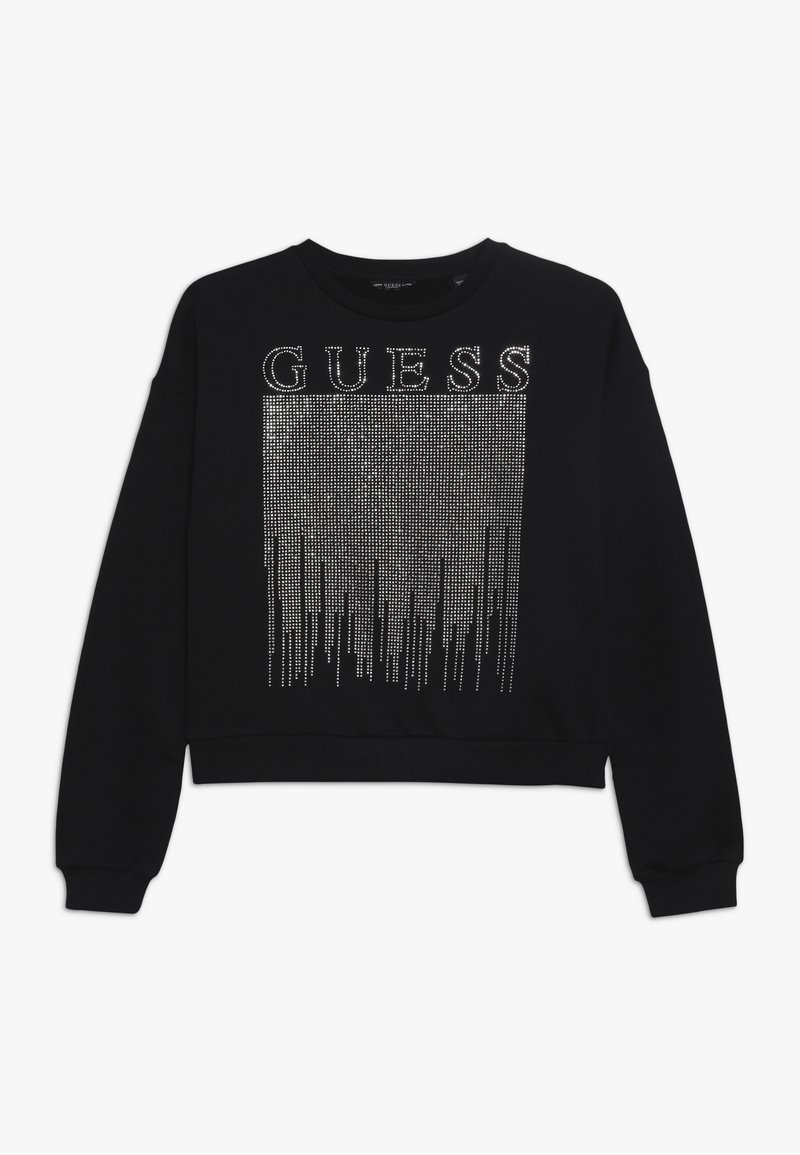 Felpa nera con un design cropped e scollatura tonda, decorata con strass argentati che formano la parola "GUESS" e motivi verticali.