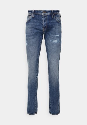 Blå denimjeans med rett snitt, med liten slitasje og opprevne områder på knærne. Klassisk fem-lommers design, glidelås-fly lukking.