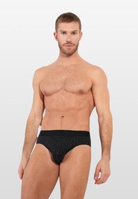 Schwarze Herrenunterwäsche mit Musterdesign, gefertigt aus einem glatten Material, mit einem breiten elastischen Bund mit Logodetails.