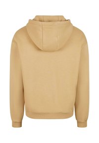 Felpa con cappuccio beige dalla texture liscia, con polsini e bordo a coste. Presenta un cappuccio a doppio strato e un design minimalista.