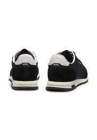 Black sneakers with suede and mesh upper, white leather accents, and black rubber sole. Features "BOSS" logo on the heel tab.