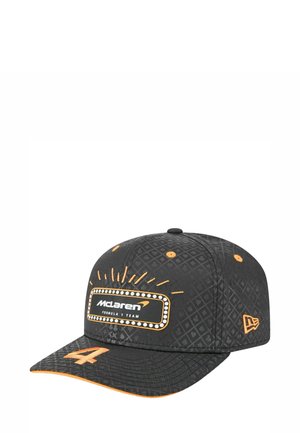 Black cap with an intricate geometric pattern, orange accents, and a white logo label for McLaren Formula 1 Team on the front.