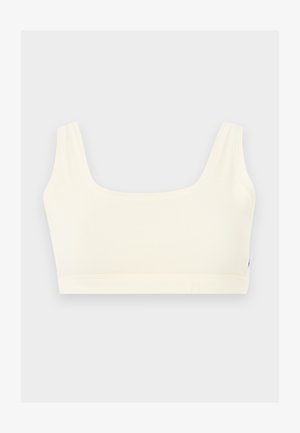 Hvid sømløs sports-bh med brede skulderstropper og firkantet halsudskæring, vist på en lys grå baggrund.
