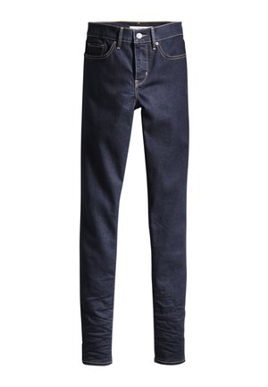 Mörkblå denimjeans med smal passform, femfickorsdesign, kontrastsytt och en metallknappstängning vid midjan.