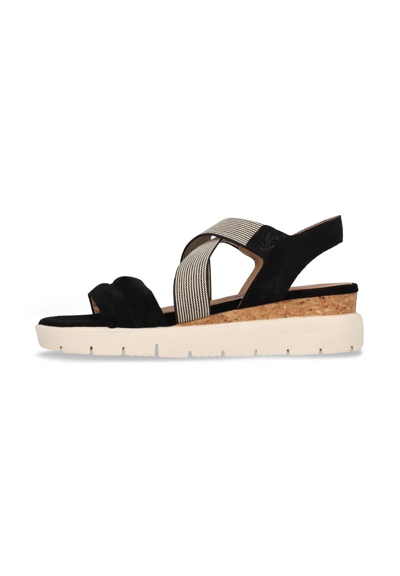 Schwarze Wildleder-Wedgesandalen mit überkreuzten elastischen Riemen und einem Korkabsatz. Die weiße Gummisohle sorgt für Rutschfestigkeit und Stabilität.