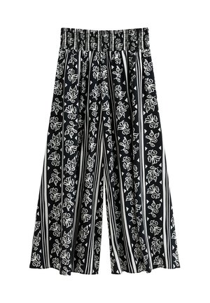 Black and white patterned wide-leg pants with an elastic waistband. Features floral and geometric prints on a striped background.
