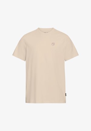 Beiges T-Shirt aus Baumwolle mit kurzen Ärmeln und rundem Ausschnitt. Auf der linken Brust befindet sich eine kleine lila Pfotenabdruck-Grafik.