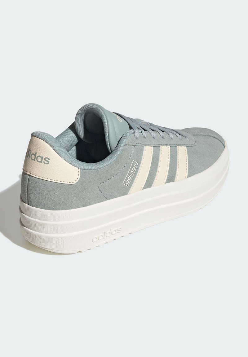 Light blue suede sneaker with white accents, featuring three white stripes, a thick white sole, and a padded collar for comfort.