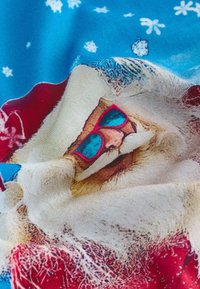 Vánoční látka s motivem usměvavého Santa Clause v červené čepici a modrých slunečních brýlích na modrém pozadí s bílými sněhovými vločkami.