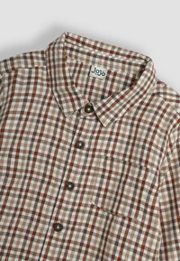 Camisa a cuadros marrón y beige con cuello abotonado, botones oscuros y bolsillo en el pecho. Hecha de tela tejida.