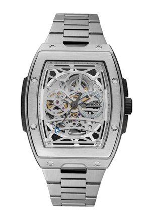 Vastschriftin van roestvrij staal met een vierkante wijzerplaat, transparante wijzerplaat die complexe tandwielen onthult, blauwe en zilveren accenten, en een schakelarmband.