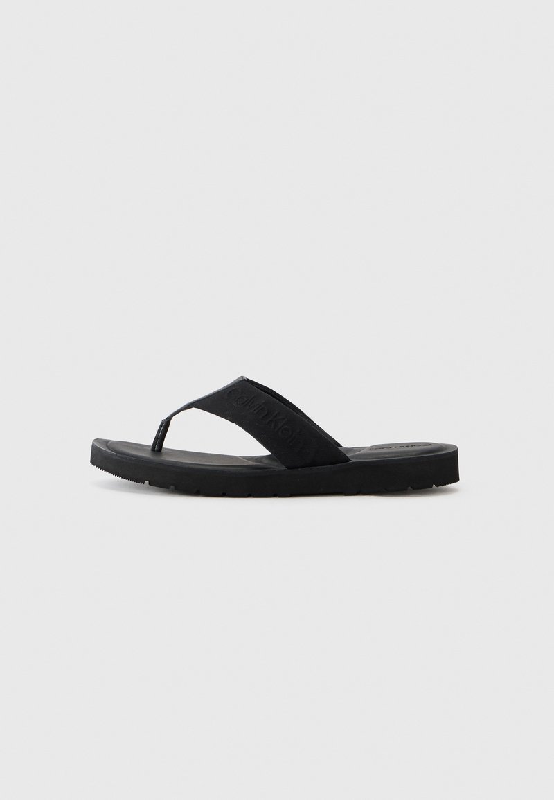 Black flip-flop sandal featuring a textured strap with logo, rubber sole, and a minimalist design. Suitable for casual wear.