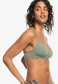 Olijfgroen bikini-top met dunne verstelbare bandjes, V-hals en geplooide stofdetails aan de voorkant. Zacht, rekbaar materiaal.
