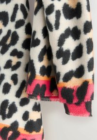 Leopardmønstret tørklæde har en cremet baggrund med sorte og brune pletter, accentueret af en pink og orange franje. Blød tekstur, rektangulær form.
