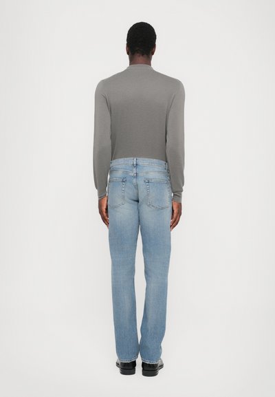 Gray long-sleeve top paired with light blue straight-leg jeans. Finished with a standard waistband and black footwear. Simple and casual design.