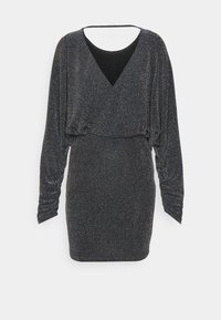 Svart klänning med långa ärmar, V-ringning och ett mjukt, texturerat tyg med metalltrådar för gnista. Draperad design vid midjan.