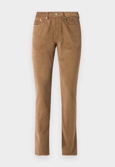 Brune corduroy bukser med en skræddersyet pasform, der har fem lommer, en knaplukning og syet detaljer langs sømmene.