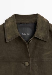 Dark green suede jacket with a collared neckline, button closure, and internal label displaying the brand name, Massimo Dutti.