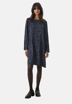 Navy blue dress made of soft fabric with a subtle leopard print pattern, long sleeves, and a loose fit, paired with black shoes.
