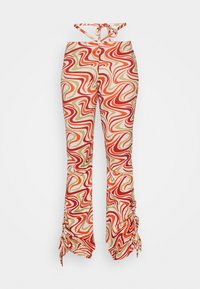 Calças flare multicoloridas com um padrão ondulante em vermelho, verde e bege, com fechos de laço na cintura e nas bainhas.