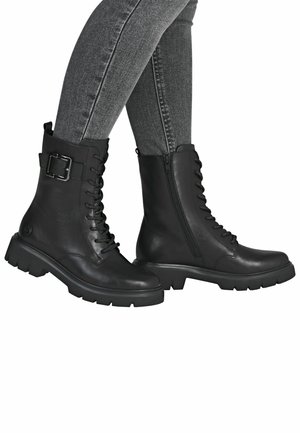 Bottines en cuir noir avec lacets, fermeture éclair latérale et accent en boucle en métal. Semelle en caoutchouc épaisse et texture lisse. Convient à diverses occasions.