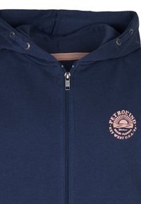 Felpa con zip di color blu navale, foderata con un tessuto testurizzato, cappuccio con cordino, zip argentata e un logo rosa con design di sole sul petto.