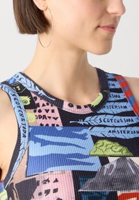 Multicolored sleeveless top with a ribbed texture, featuring various graphic patterns in blue, pink, green, and black. Round neckline design.