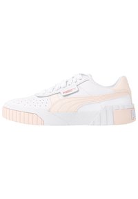 Vita sneakers med rosa accenter, texturerat läder, perforerat ovandel, vita snören och en kraftig sula med vertikala ribbor och branding.