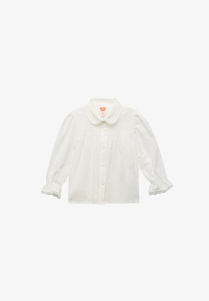 Camisa blanca de botones con cuello redondeado, mangas largas y un borde de encaje en los puños. Presenta un tejido texturizado con pequeños puntos en relieve.