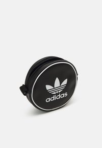 Borsa circolare nera in similpelle, con logo Adidas bianco e strisce. Include una cerniera e un piccolo manico.