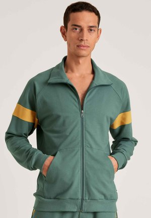 Groene zip-up jas van katoen, met gele schouderstrepen, zijzakken en een kraag. Zachte, gestructureerde stof met geribbelde manchetten.