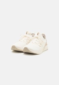 White athletic shoes with a textured mesh upper, lace closures, and light-colored rubber soles. Features subtle branding accents.