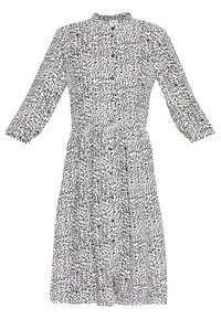 Abito bianco e nero con colletto, maniche lunghe, chiusura a bottoni e un motivo astratto con forme e dimensioni variabili.