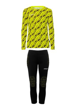 Haut à manches longues jaune vif avec un motif en zigzag noir. Pantalons noirs avec des coussinets de genoux renforcés et des accents jaunes. Coupe sportive et extensible.