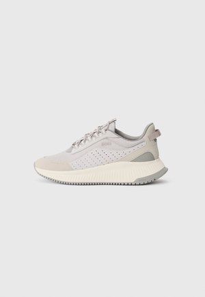 Light gray athletic shoes with mesh and synthetic upper, perforated detailing, contrasting beige accents, and a textured rubber sole.