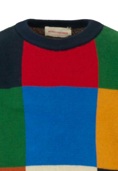 Jersey de lana multicolor con patrones de bloques en rojo, azul, verde, amarillo y negro. Presenta un cuello de canalé en navy y una tela texturizada.
