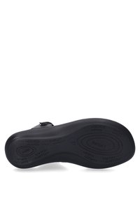 Black sandal sole with textured grip, engraved brand details, and contoured shape for comfort. Durable rubber material with soft padding.